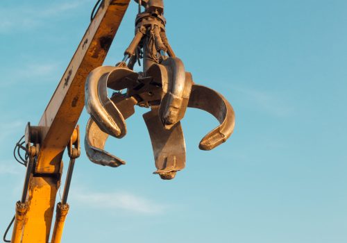 crane arm with open claw on clear blue sky